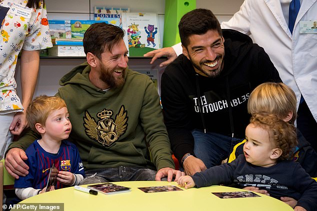 Lionel Messi (left) and Luis Suarez visited children at a hospital in Barcelona on Friday