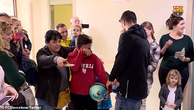The tearful young football supporter received a ball signed by both strikers on Friday