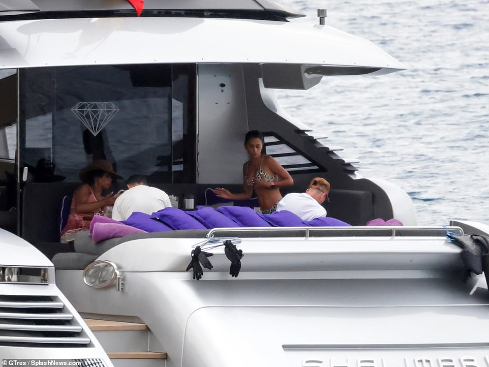 Bikini body: The stunner showed off her gym-honed physique in the green bikini which had a leopard print design