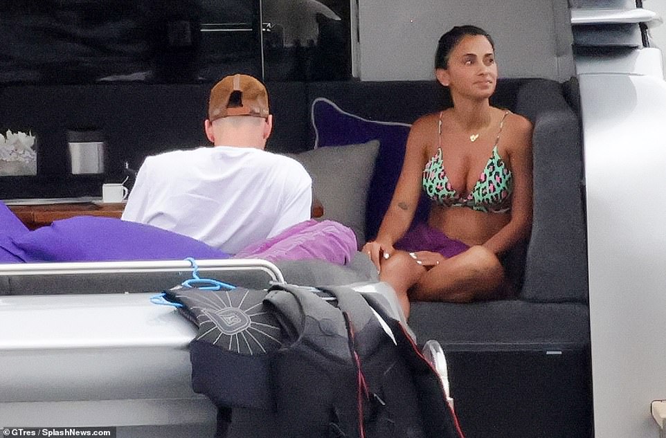 Footballer: Meanwhile Lionel looked happy and relaxed in a white McQueen T-shirt he teamed with patterned shorts and a casual cap