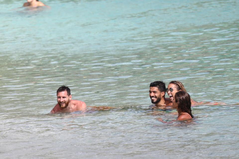  The close friends laughed in the sea as they relaxed in the sun